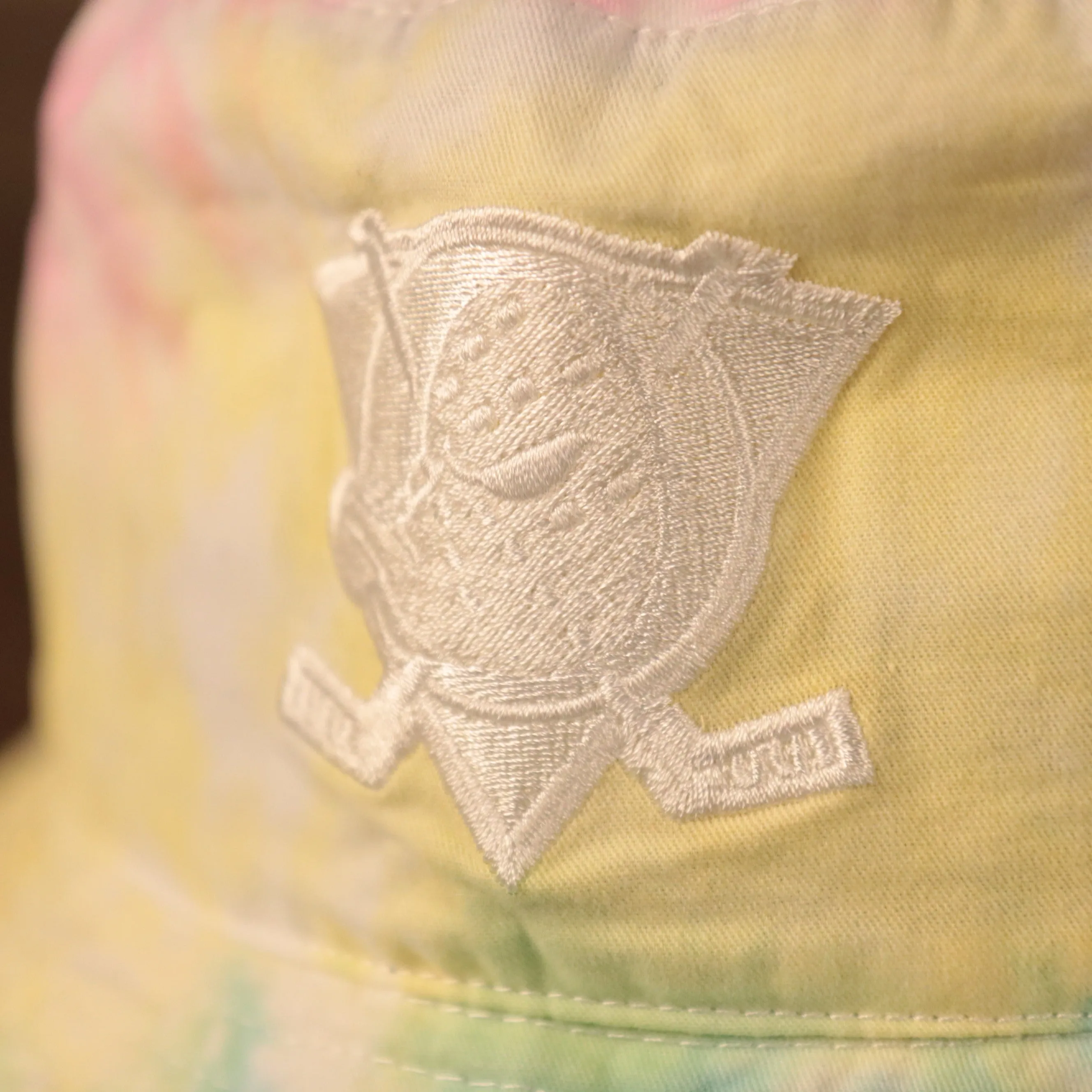 Anaheim Ducks bucket hat with tie dye design and Ducks logo patch on the front - One size fits most (OSFM).