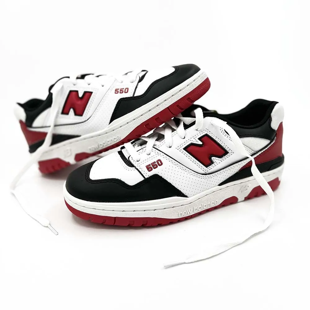 New Balance 550 sneakers in white, red, and black.